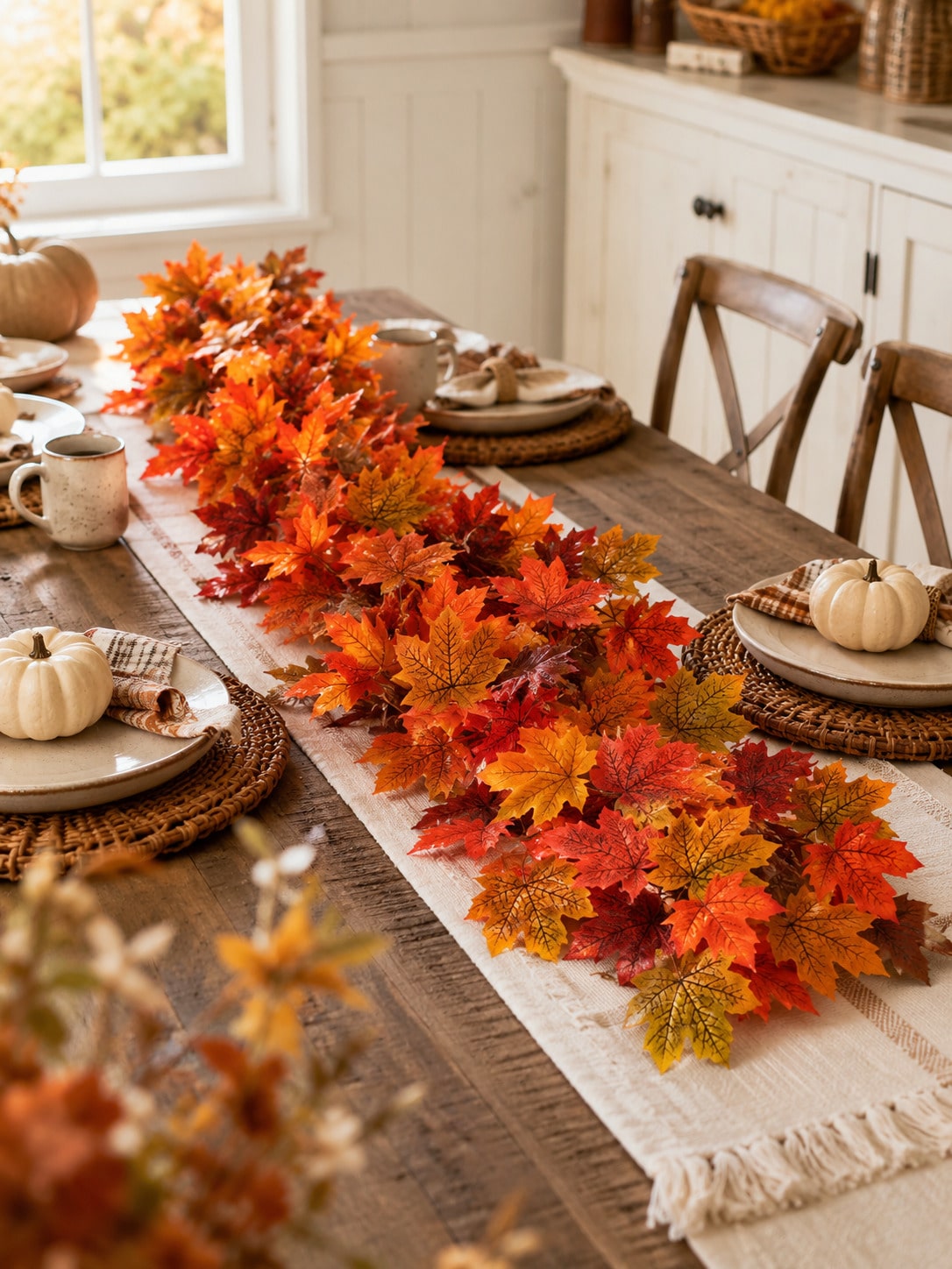 Artificial maple leaf garland as a table runner on a dining table