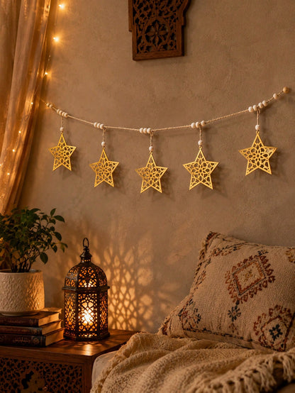 gold cutout star garland styled in a room, photo 10