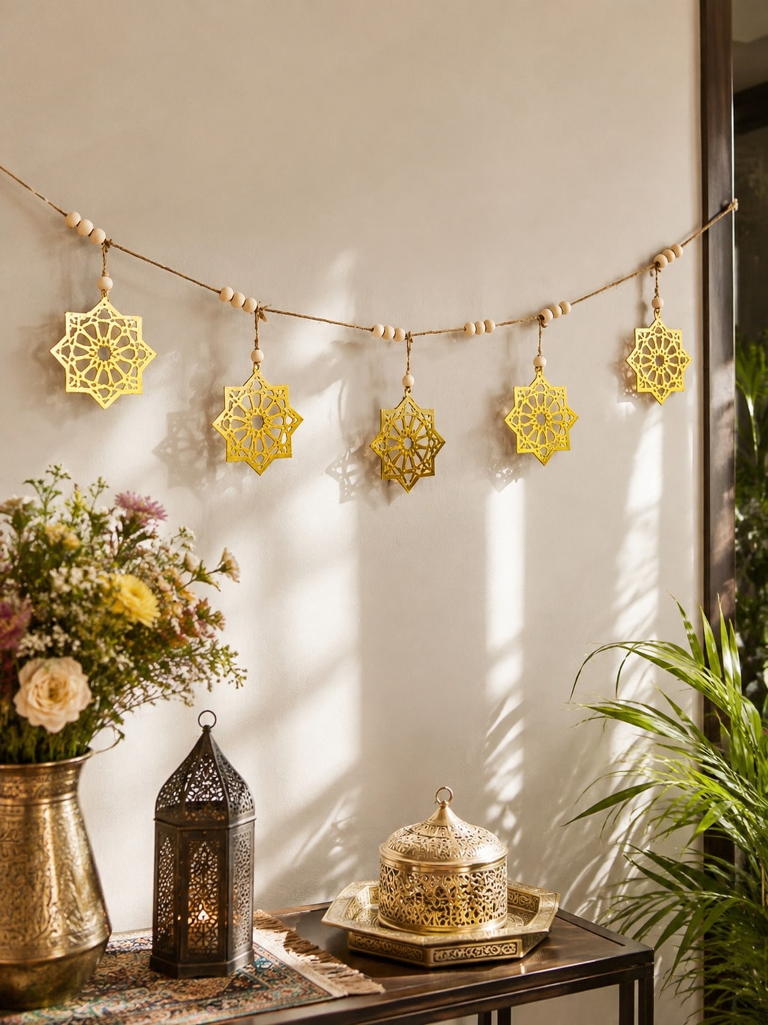 gold eight-point star garland styled in a room, photo 2