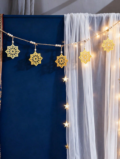 gold eight-point star garland styled in a room, photo 3