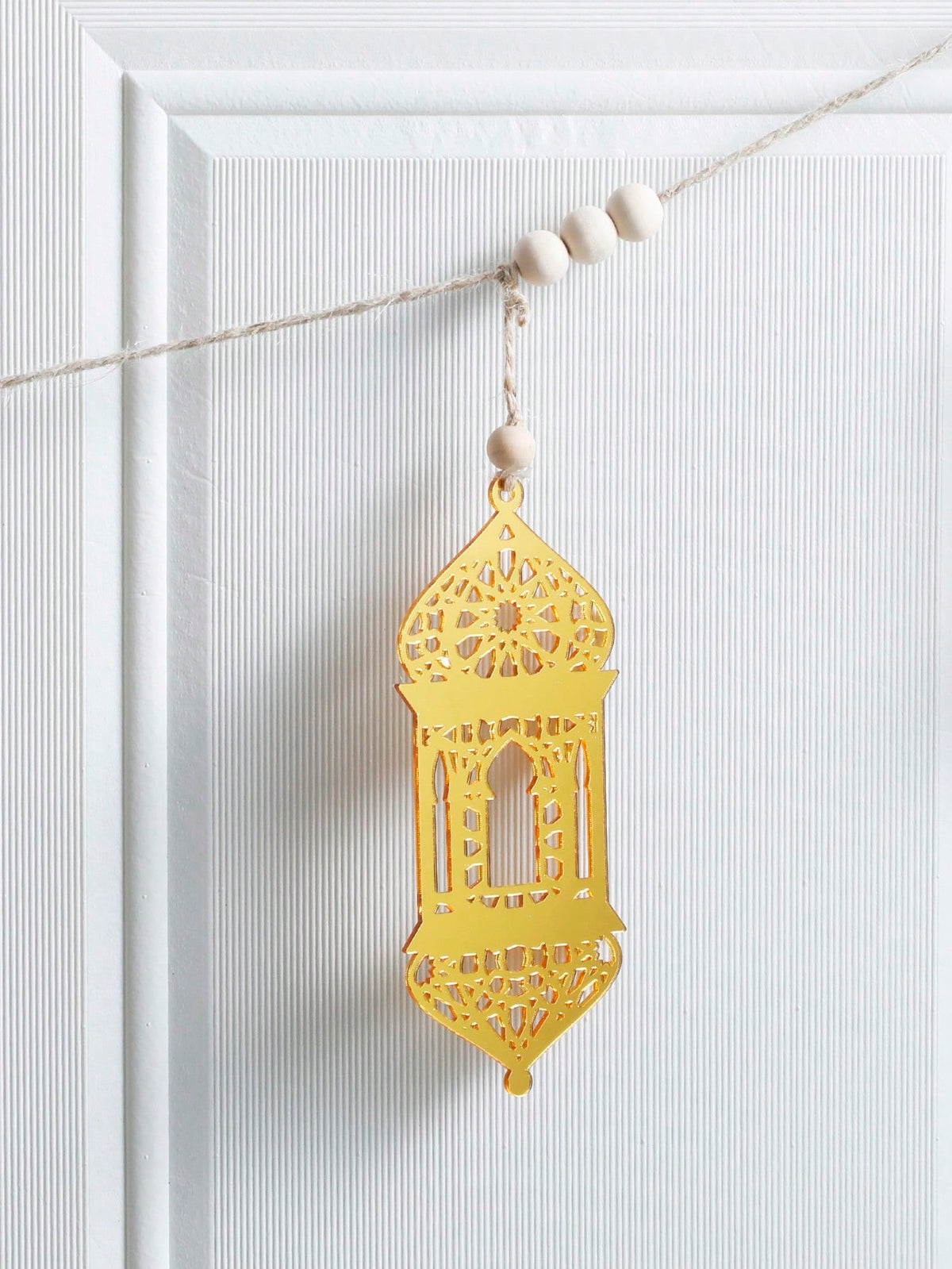 gold geometric lantern garland styled in a room, photo 4