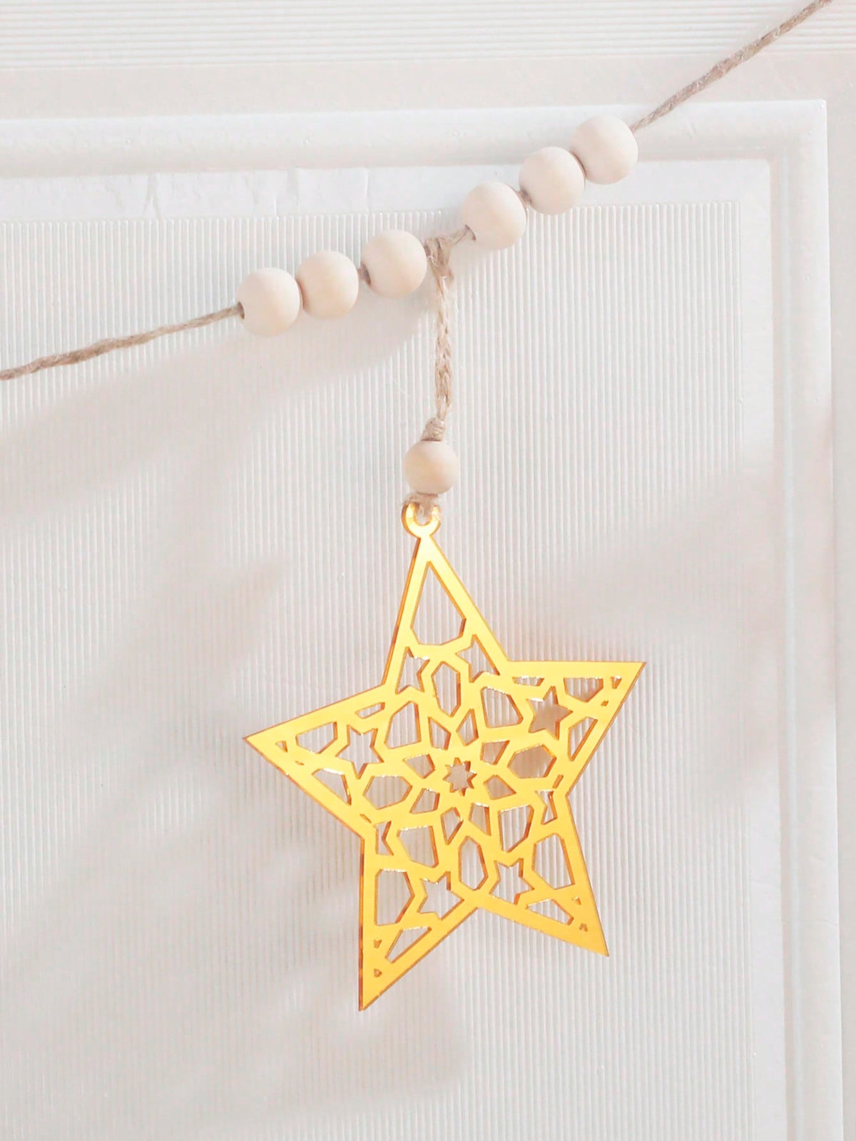 gold cutout star garland styled in a room, photo 4