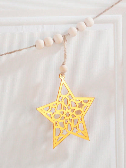 gold cutout star garland styled in a room, photo 4