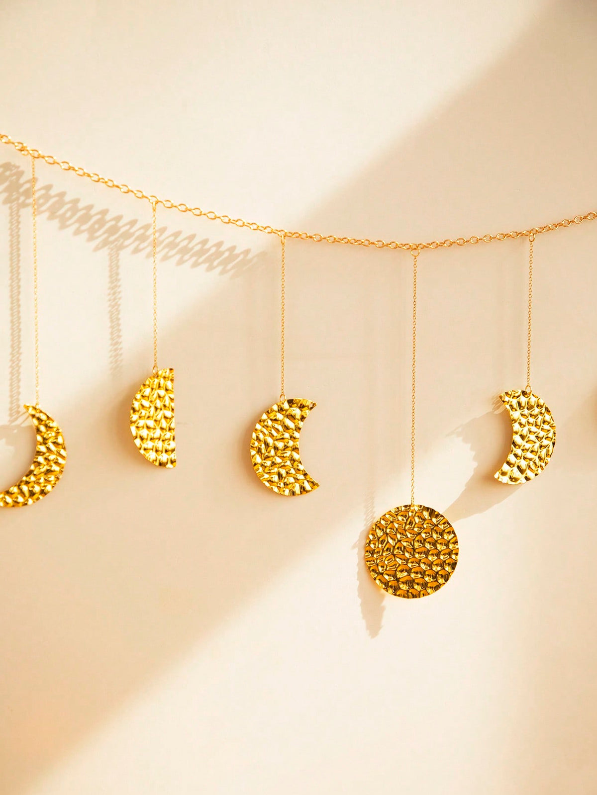 gold moon phase garland styled in a room, photo 6