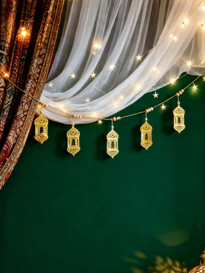 gold geometric lantern garland styled in a room, photo 6