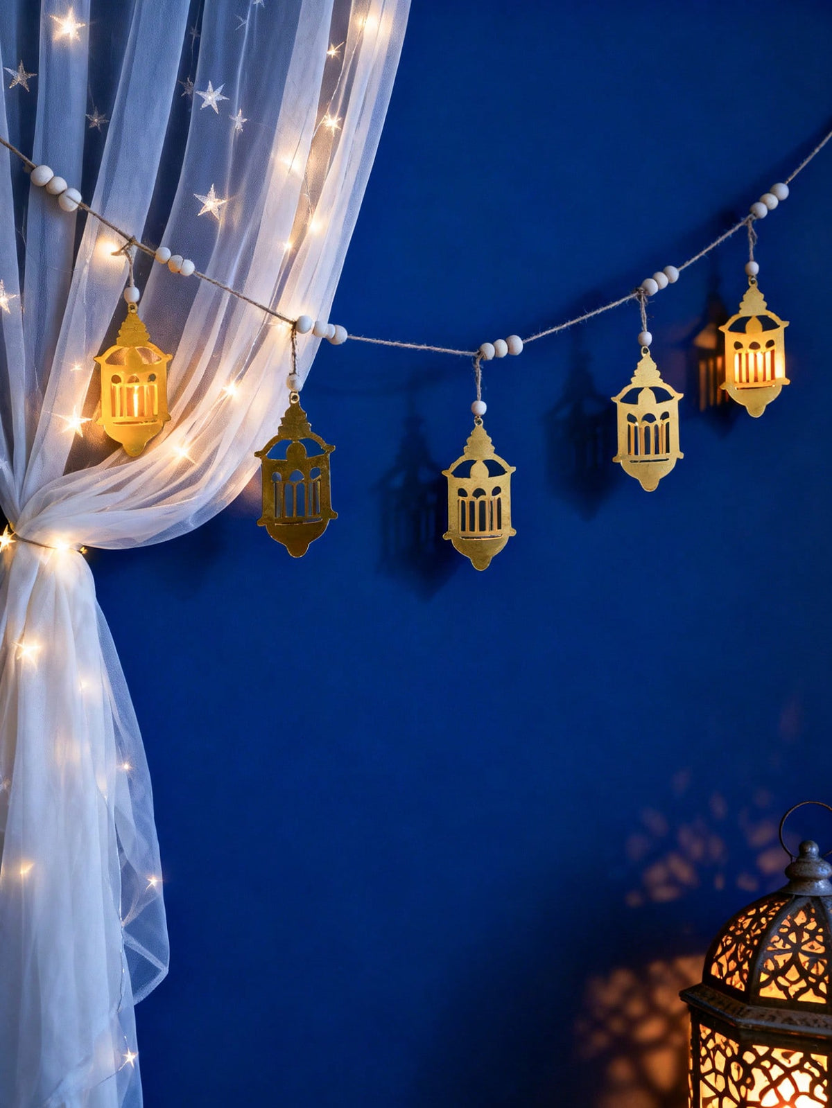gold filigree lantern garland styled in a room, photo 7