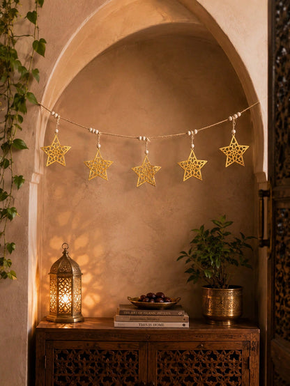 gold cutout star garland styled in a room, photo 9