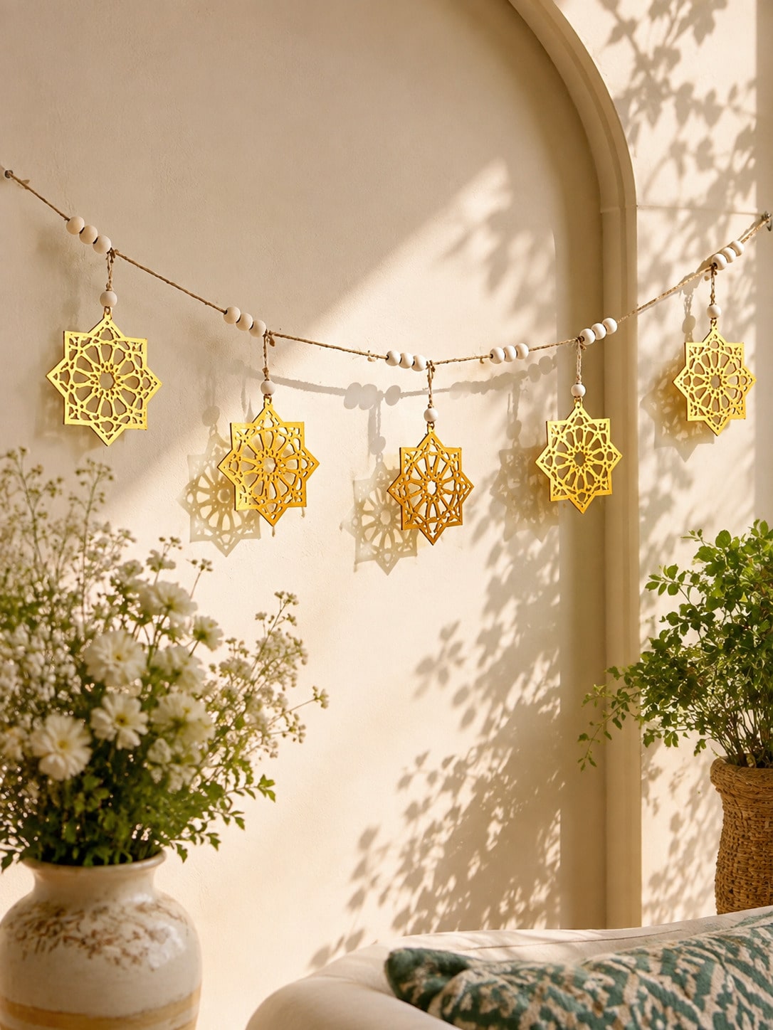 gold eight-point star garland styled in a room, photo 8