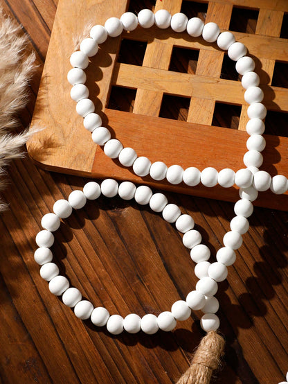 wood bead garland with tassels - White styled photo