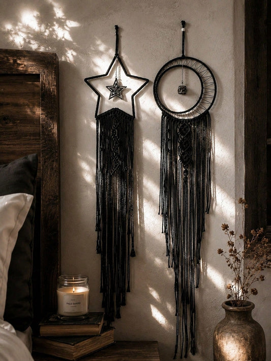 Black macrame moon dream catcher pair beside a bed with candle