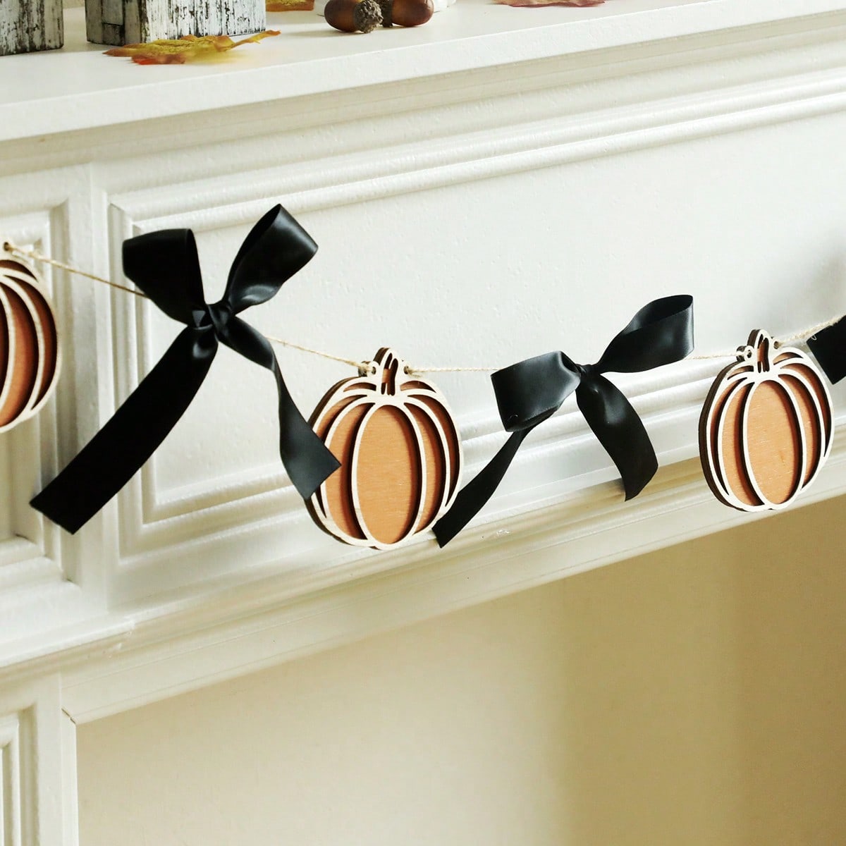 Pumpkin garland with black bows close-up of pumpkins and bows