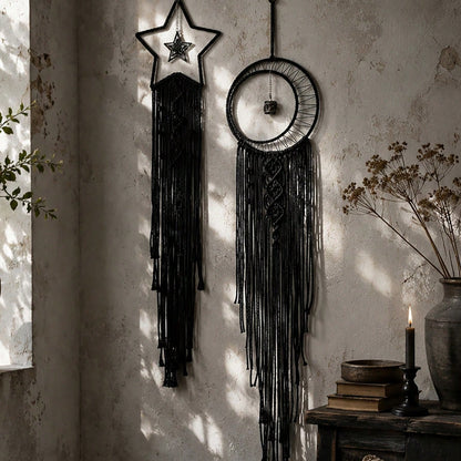 Black macrame moon dream catcher close-up in window sunlight