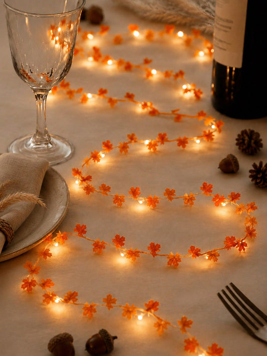 Maple leaf fairy string lights orange, glowing table close-up