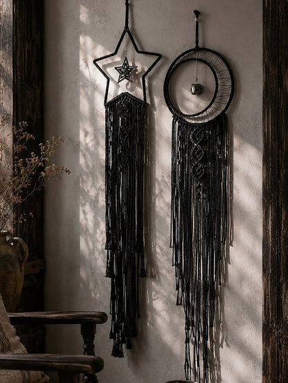 Black macrame moon dream catcher pair on a plaster wall
