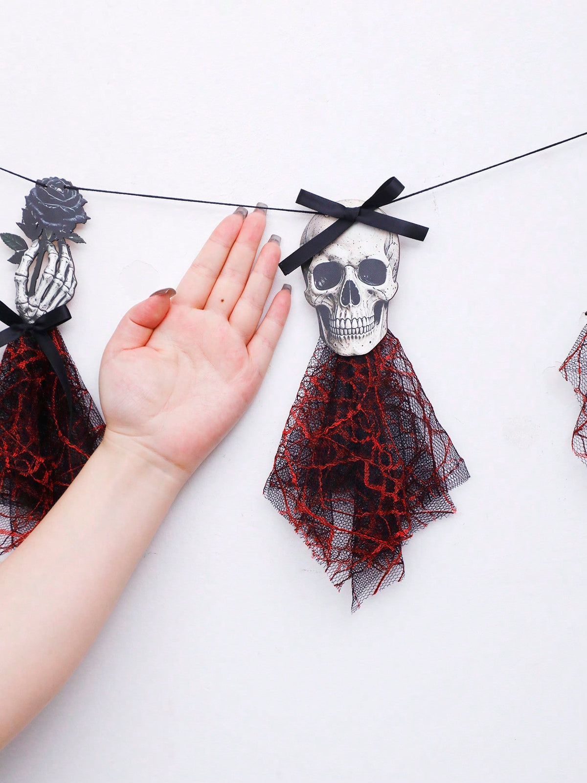 Gothic skeleton Halloween banner skull piece with red tulle held in hand