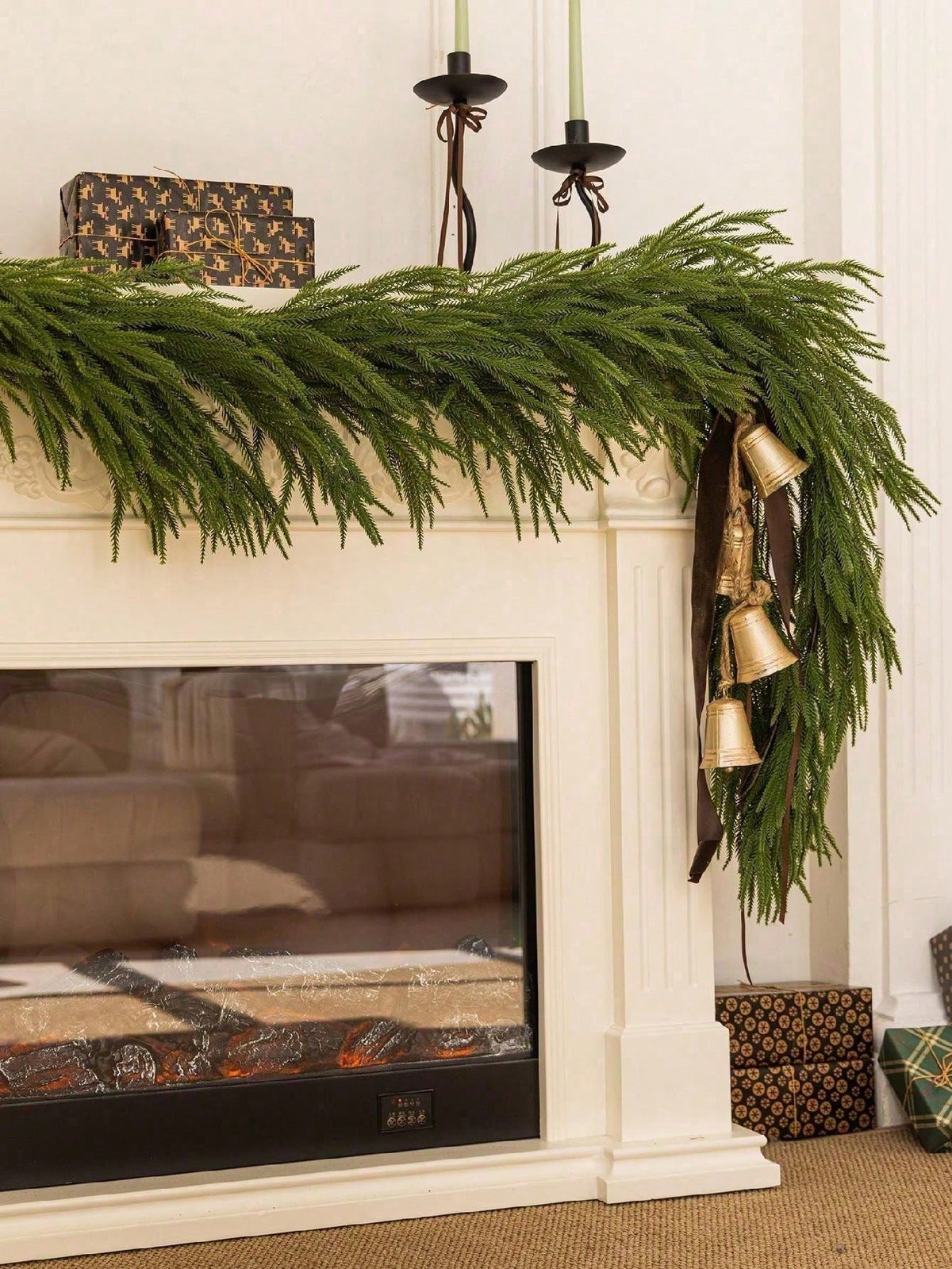 Artificial cedar Christmas swag on a white fireplace