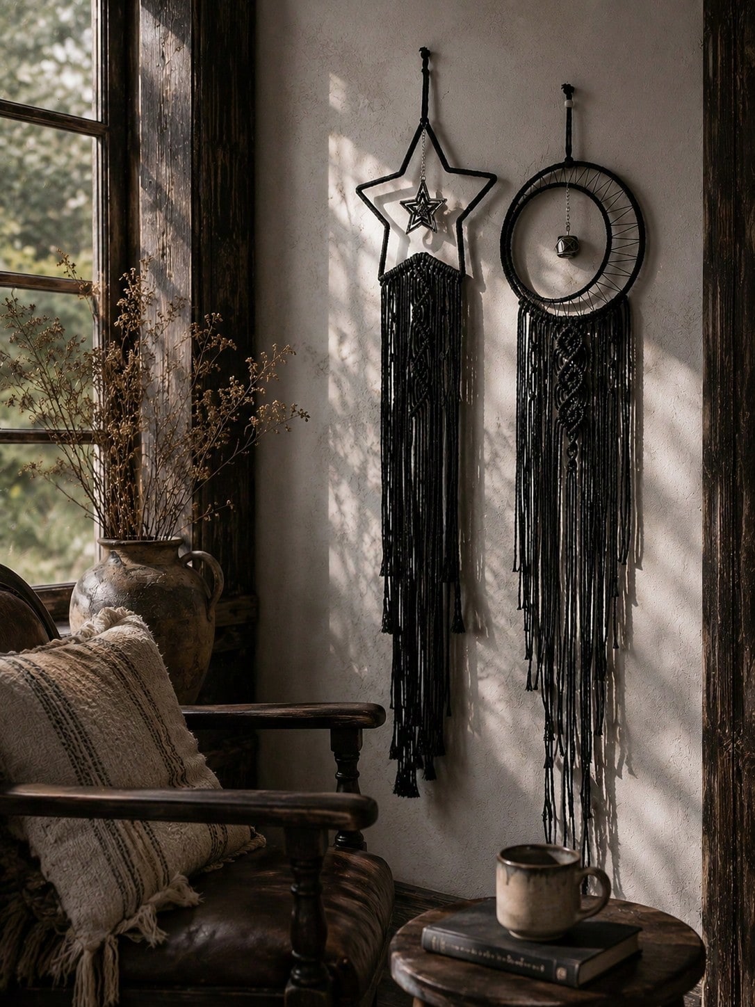 Black macrame moon dream catcher pair beside a window