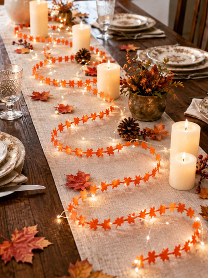Maple leaf fairy string lights orange, along a table runner with candles