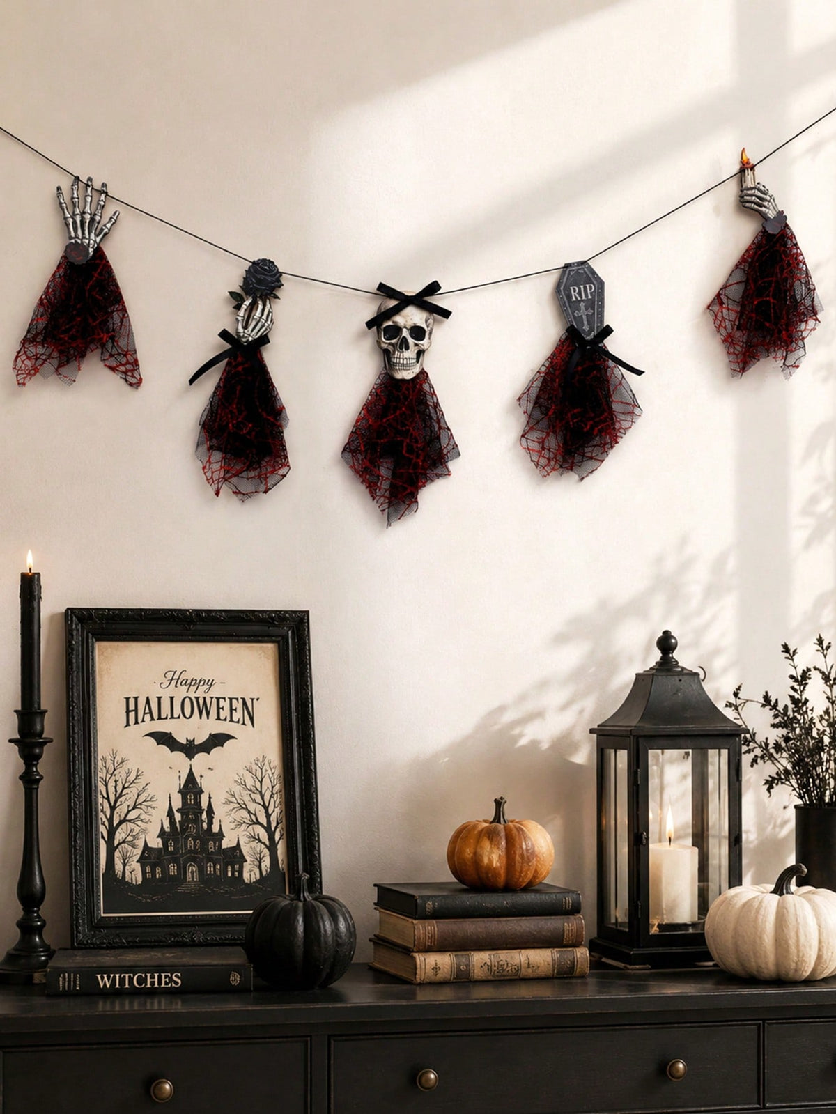 Gothic skeleton Halloween banner on a wall above a console with lantern