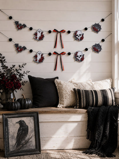 Gothic skull Halloween garland with roses above a window seat with pillows