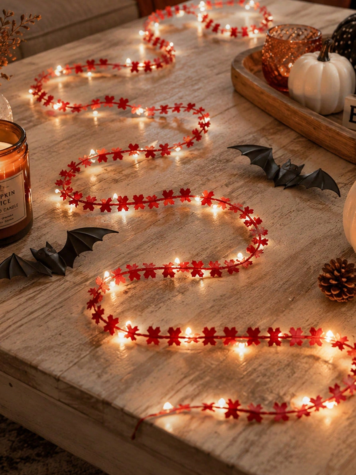 Maple leaf fairy string lights orange, on a wooden table