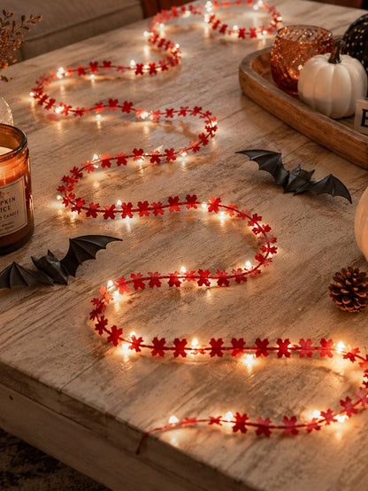 Maple leaf fairy string lights orange, on a wooden table