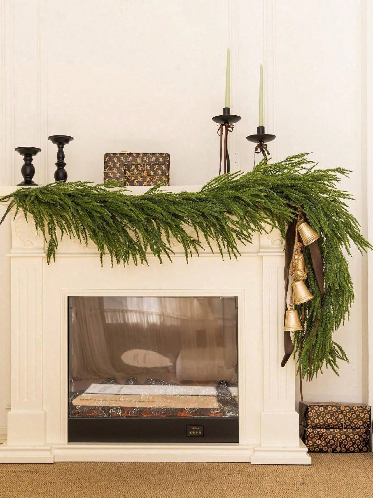 Artificial cedar Christmas swag across a mantel with candlesticks