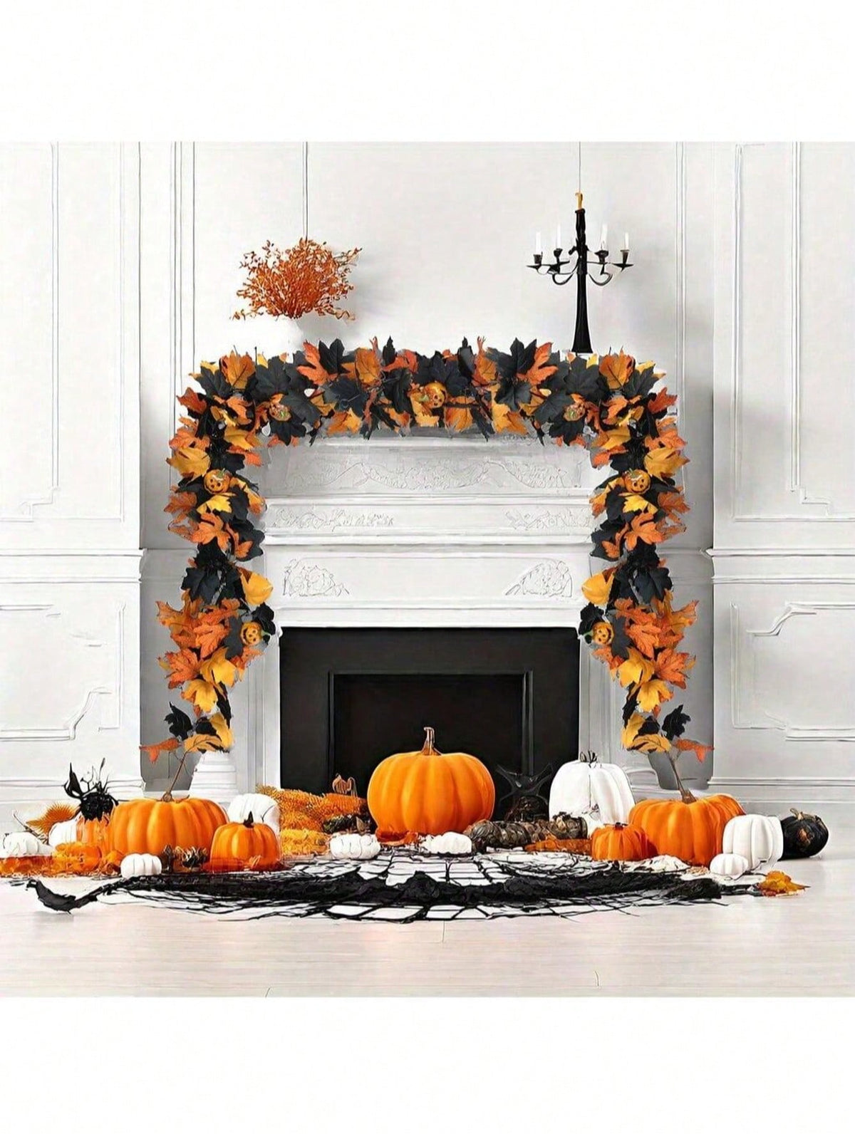 Halloween maple leaf garland across a fireplace with pumpkins