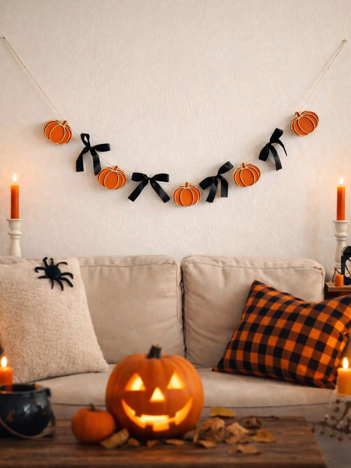 Pumpkin garland with black bows above a sofa
