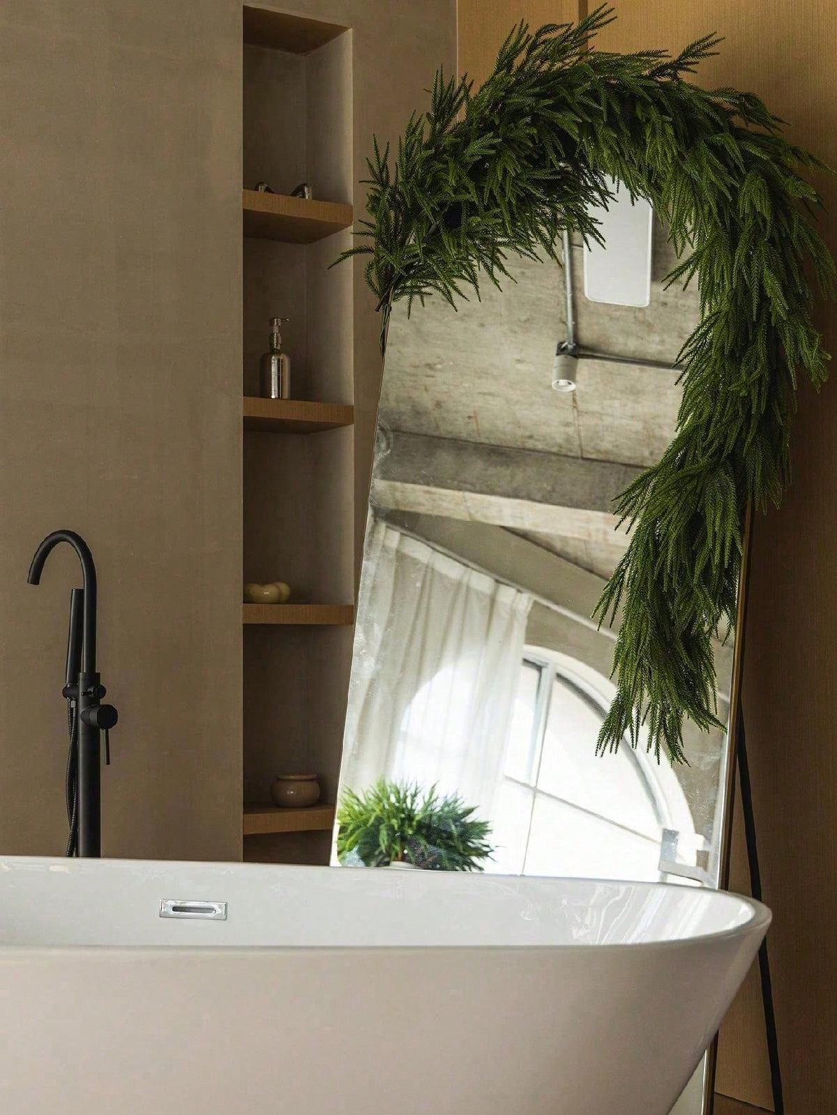 Artificial cedar Christmas swag framing a bathroom arch