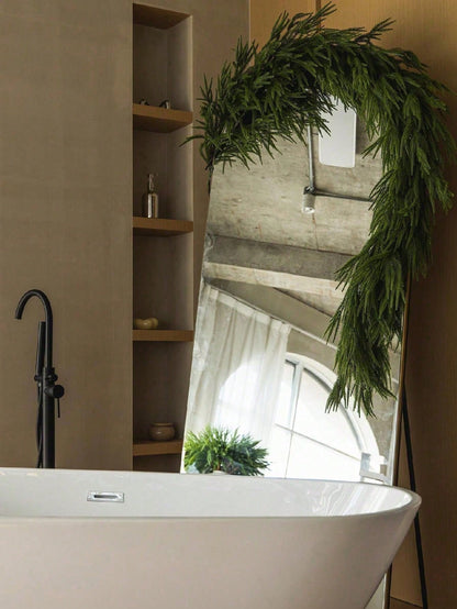 Artificial cedar Christmas swag framing a bathroom arch