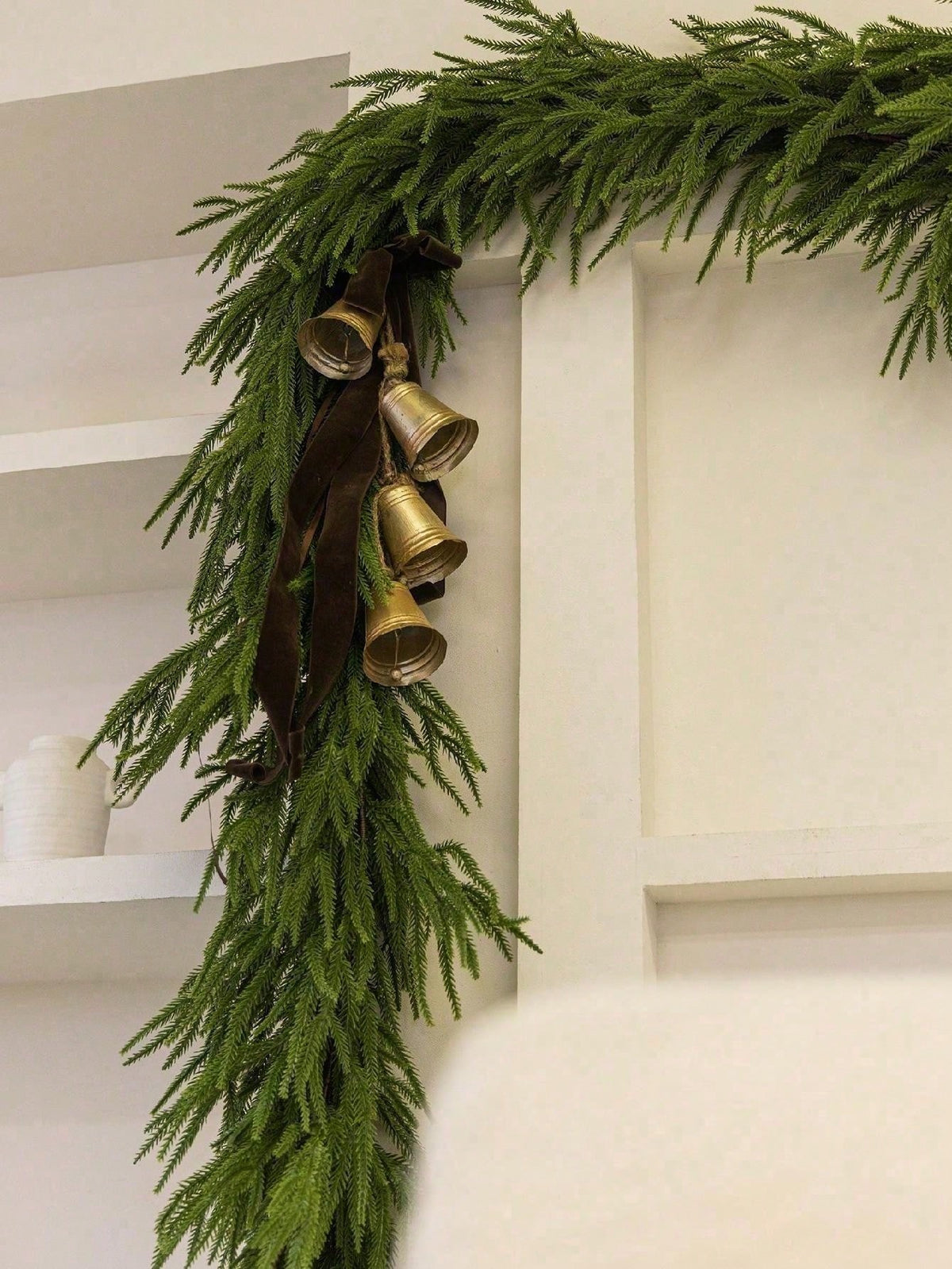 Artificial cedar Christmas swag on a shelf corner