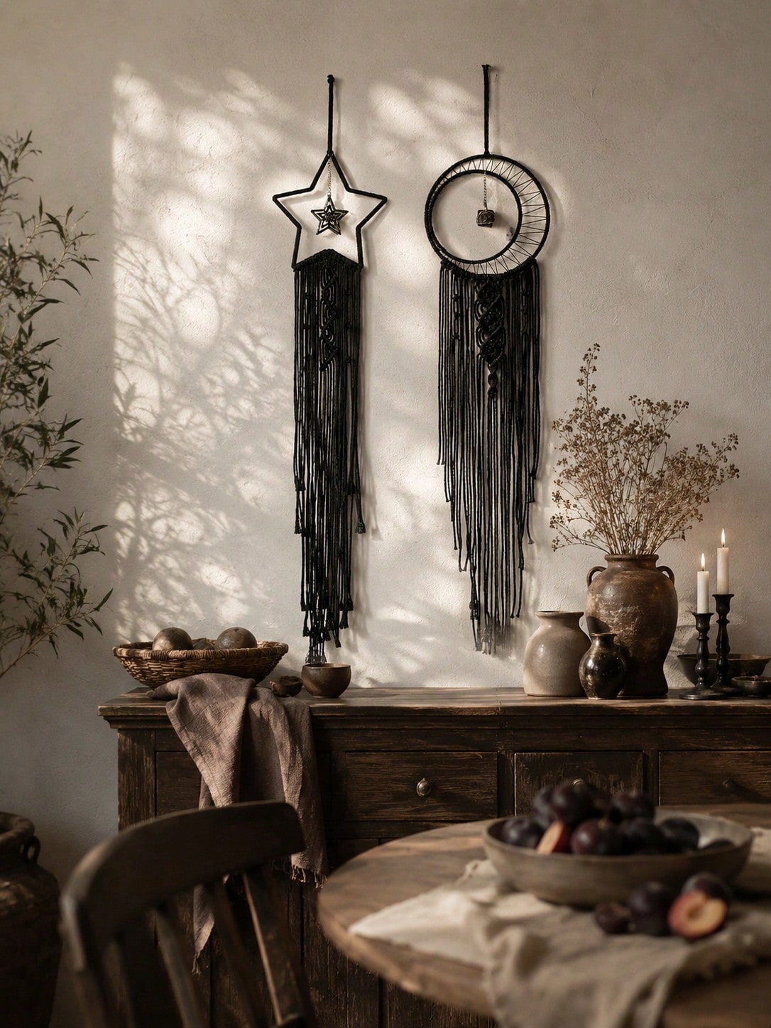 Black macrame moon dream catcher pair above a dining table