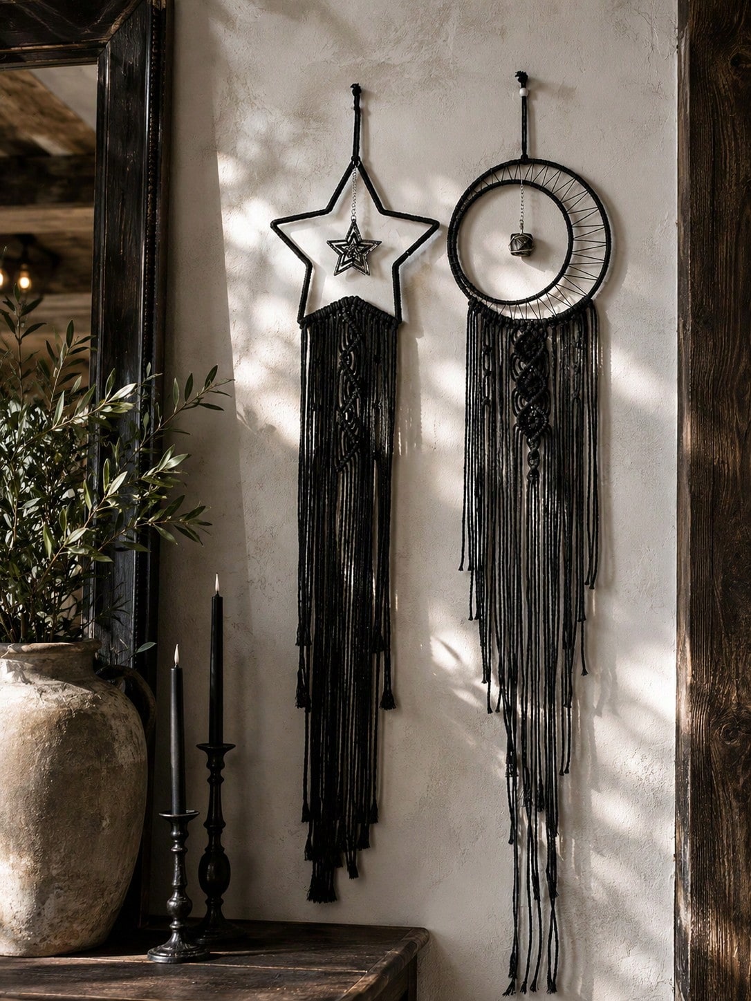 Black macrame moon dream catcher pair in a rustic hallway