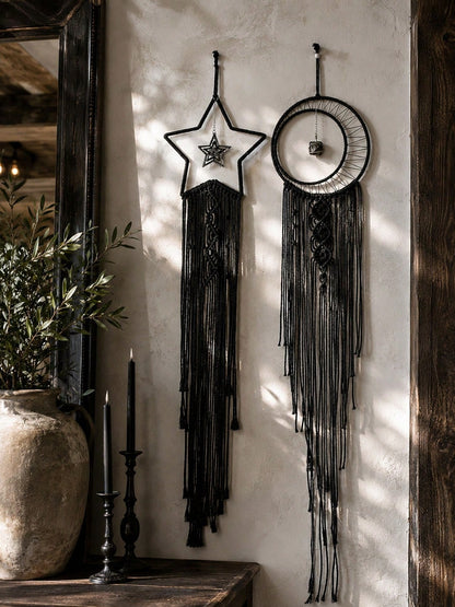 Black macrame moon dream catcher pair in a rustic hallway