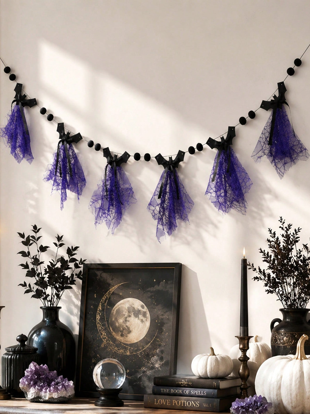 Purple bat Halloween banner on a wall above a shelf with moon art